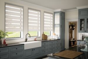Band shades in the open position on three kitchen windows in a designer farmhouse kitchen in Bridgeland, TX