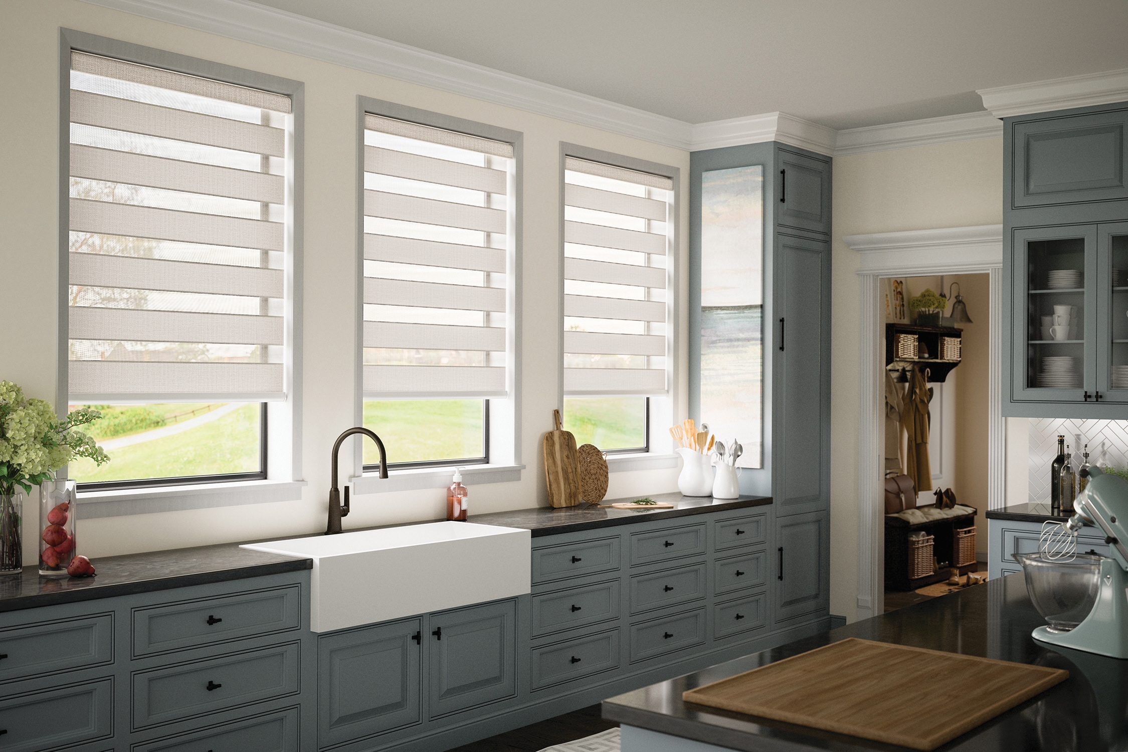 Band shades in the open position on three kitchen windows in a designer farmhouse kitchen in Bridgeland, TX
