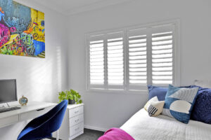 Plantation shutters in a vibrant colorful bedroom in Bridgeland TX