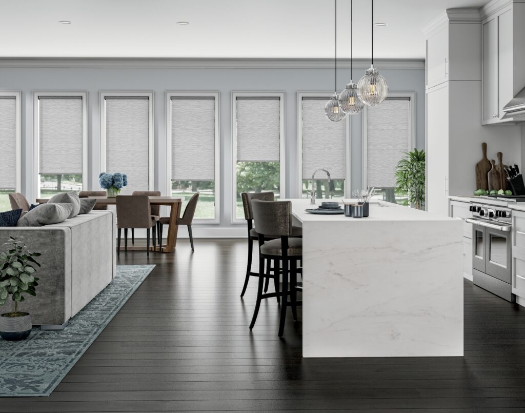 Grey roller shades installed across an open-plan kitchen, dining, and living area in Bridgeland, TX
